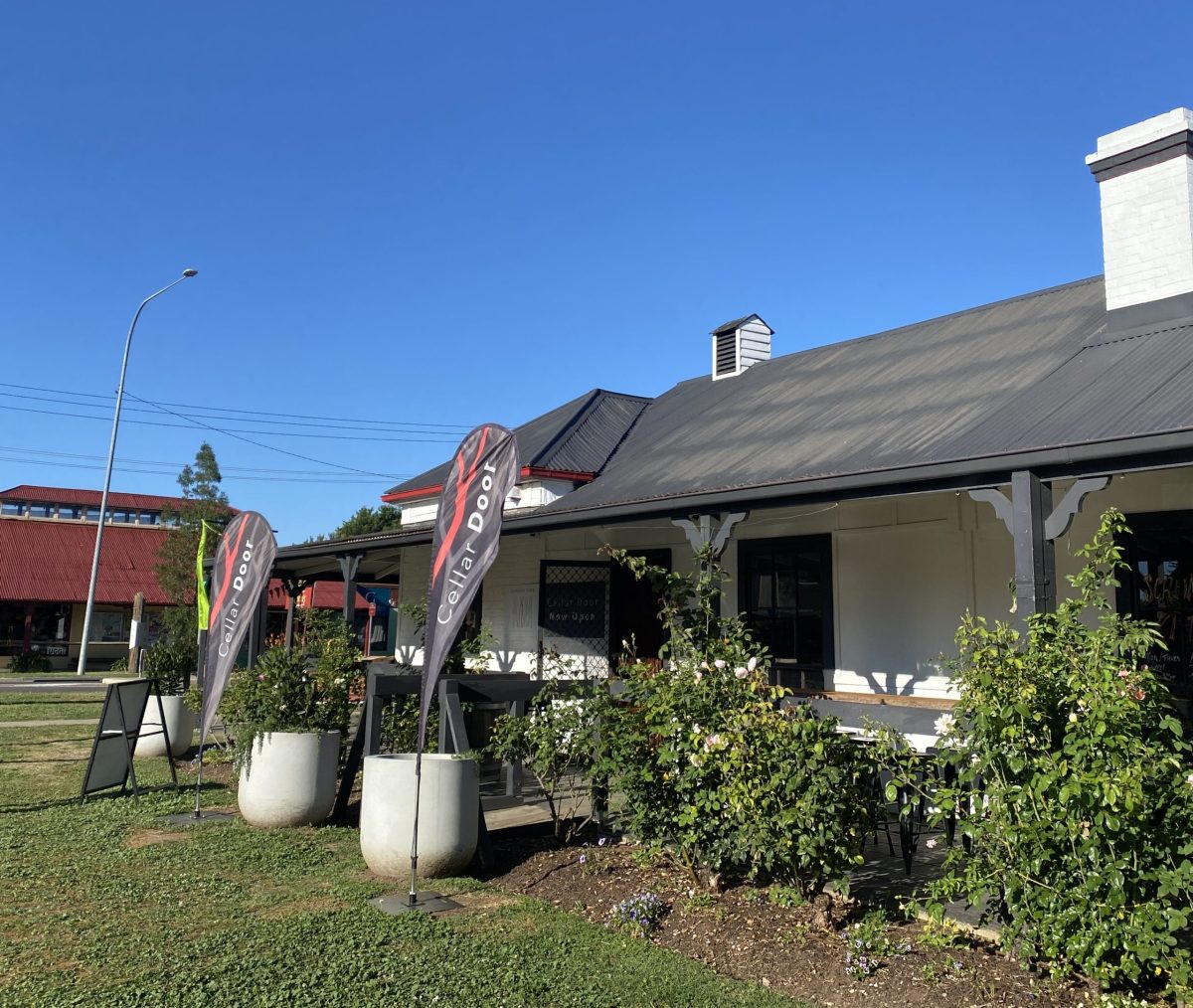 Sunny exterior shot of building showing Cellar Door banners.