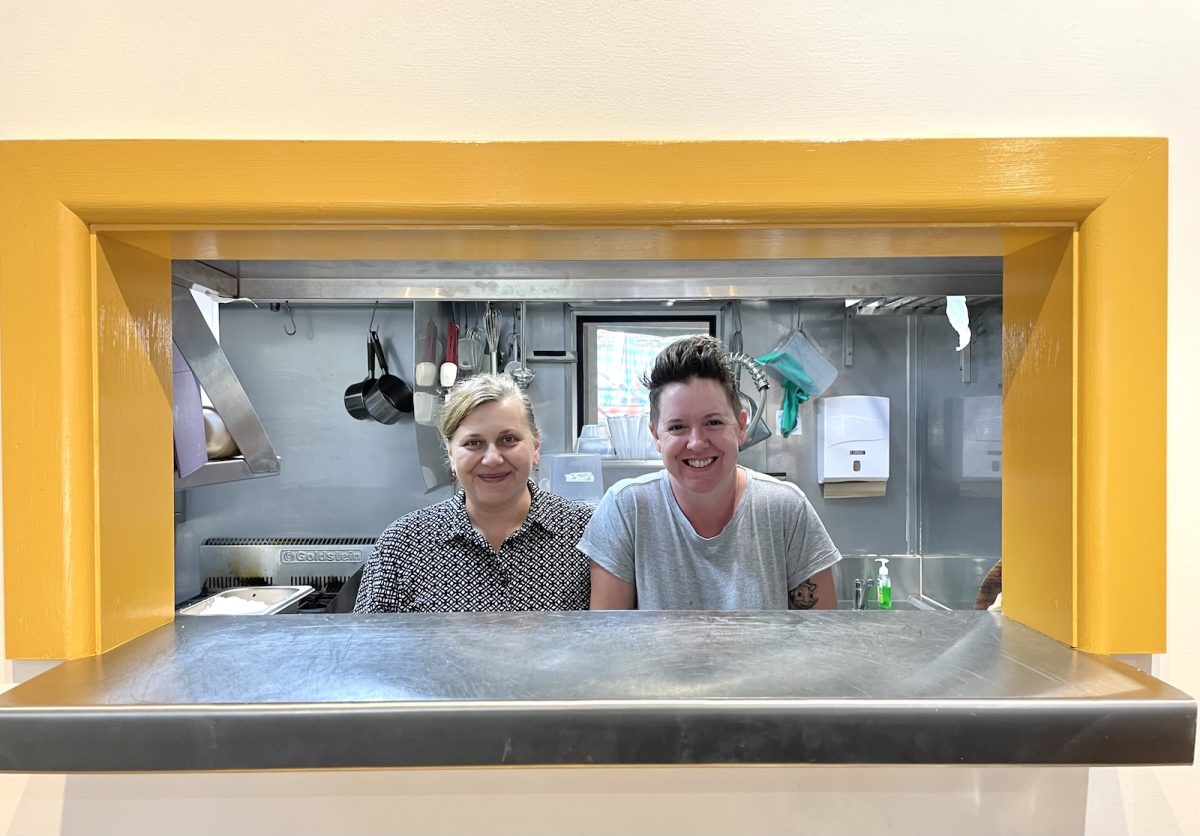 Larissa Terry and Stacey Russell smiling from the kitchen at Toast Eden.