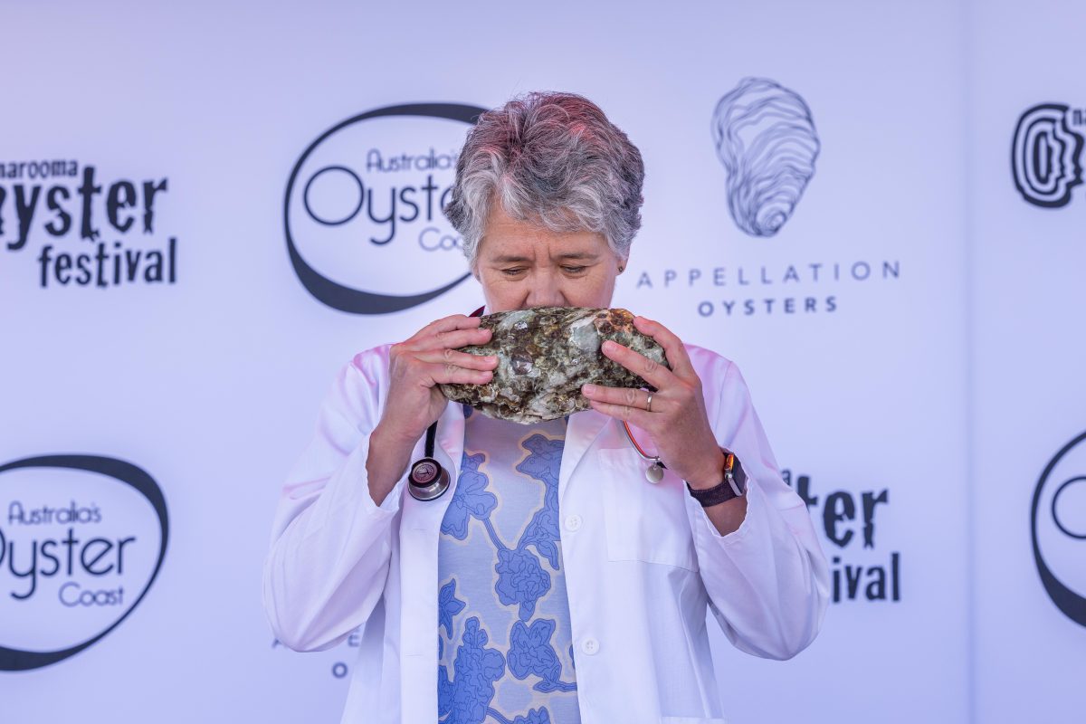 woman sniffing an oyster