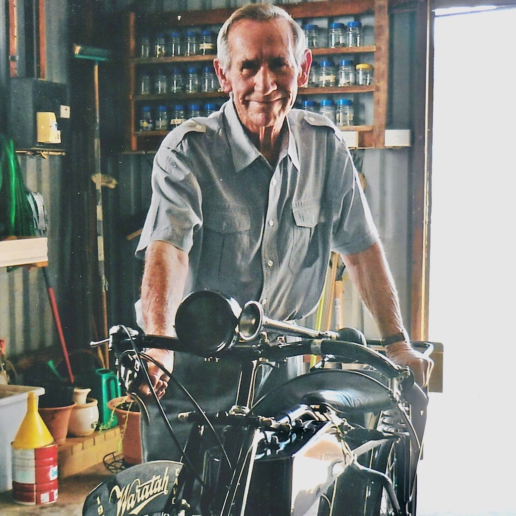 Merv Seymour in retirement with a satisfied grin, near the Waratah he lovingly restored with the help of his son Peter.