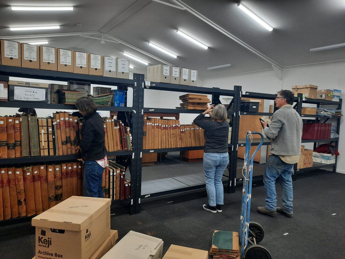 People moving large shelves