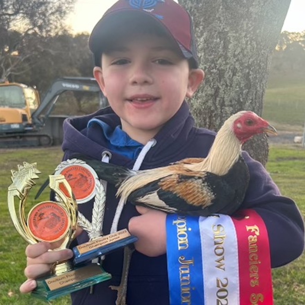 boy with show bird and awards