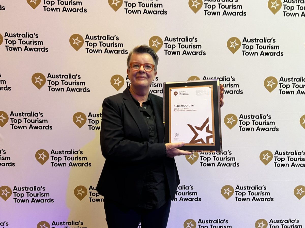 Woman holding framed award 