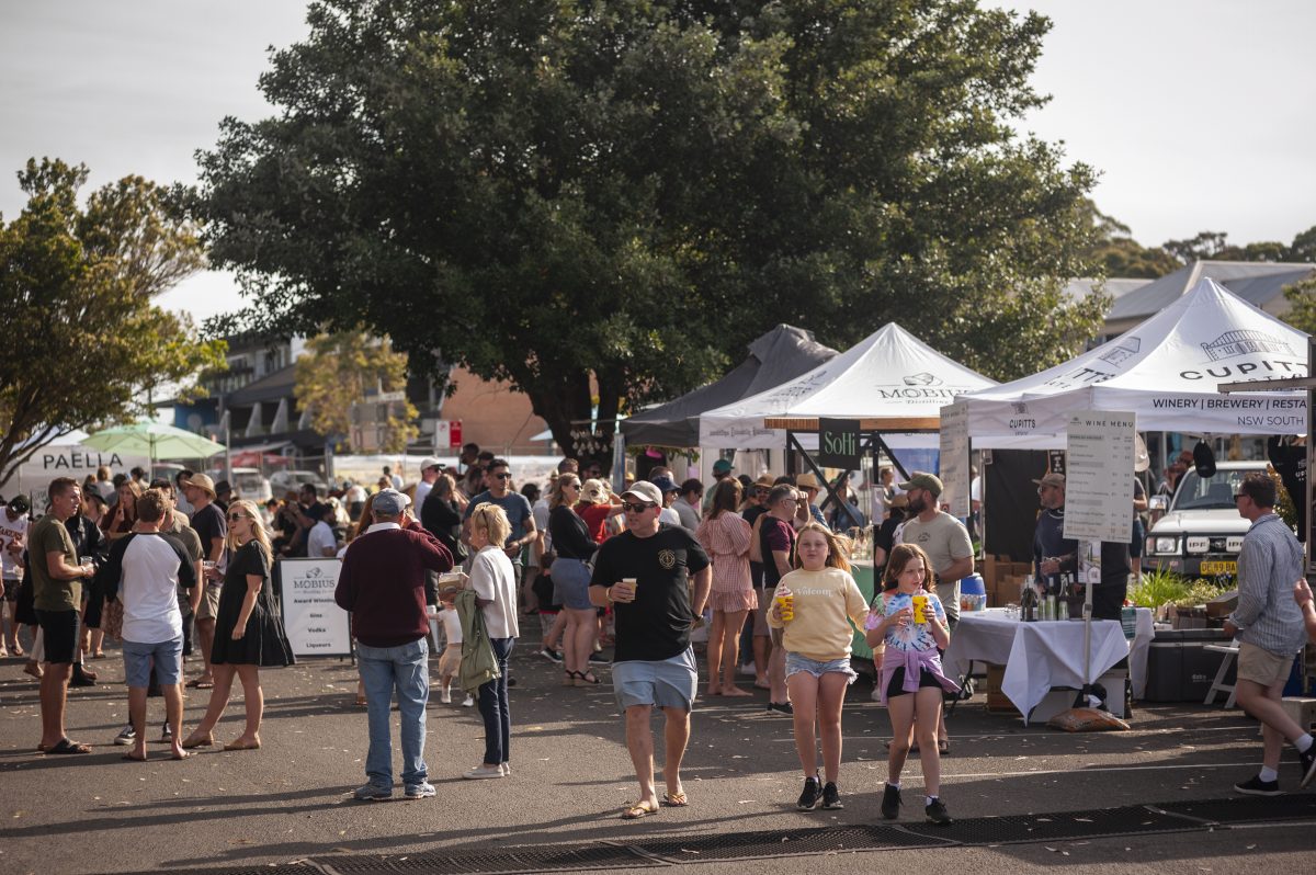 A crowd of people walking through a festival