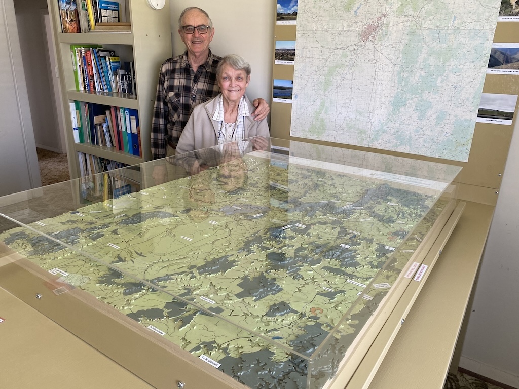 A man and a woman with a 3D landscape model of Goulburn and the surrounding area