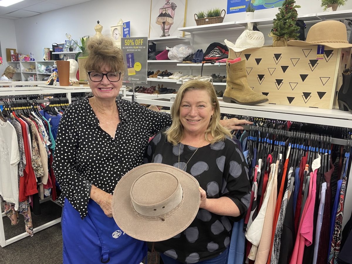 two women holding a hat inside Goulburn Vinnies