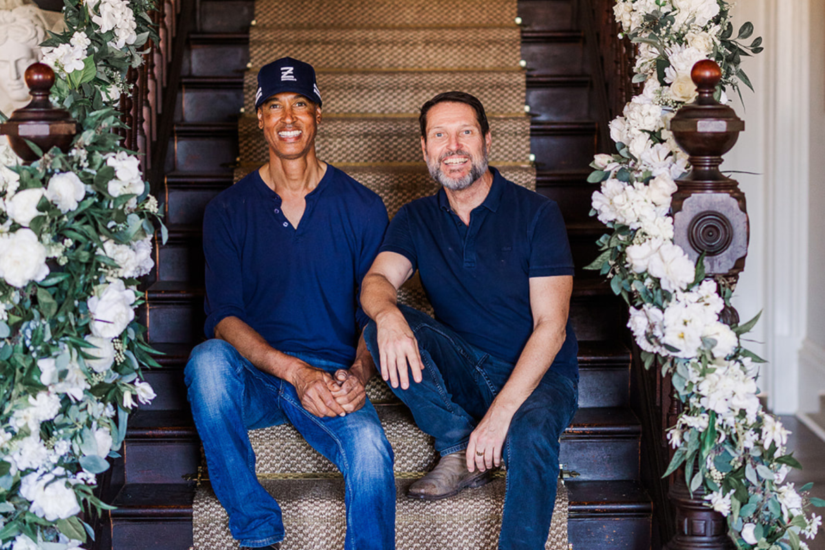 Two men sitting on a staircase.