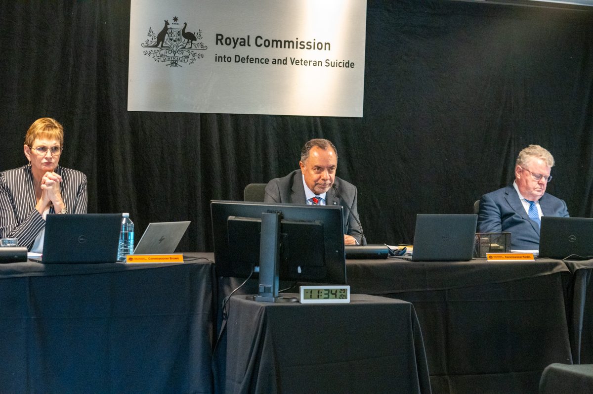 three people leading a government hearing 