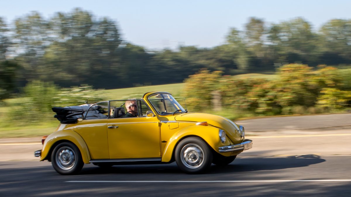 A yellow convertible Volkswagen Beetle