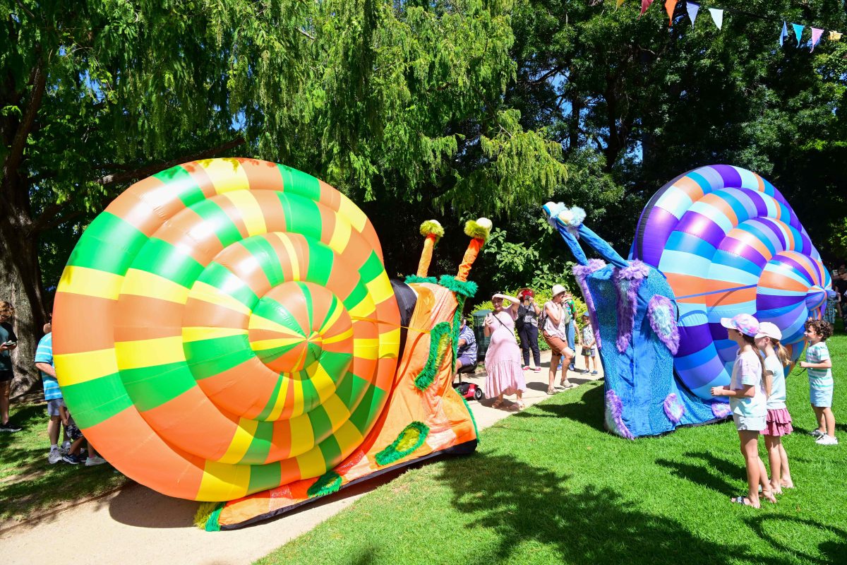 kids in a garden with inflatable snails